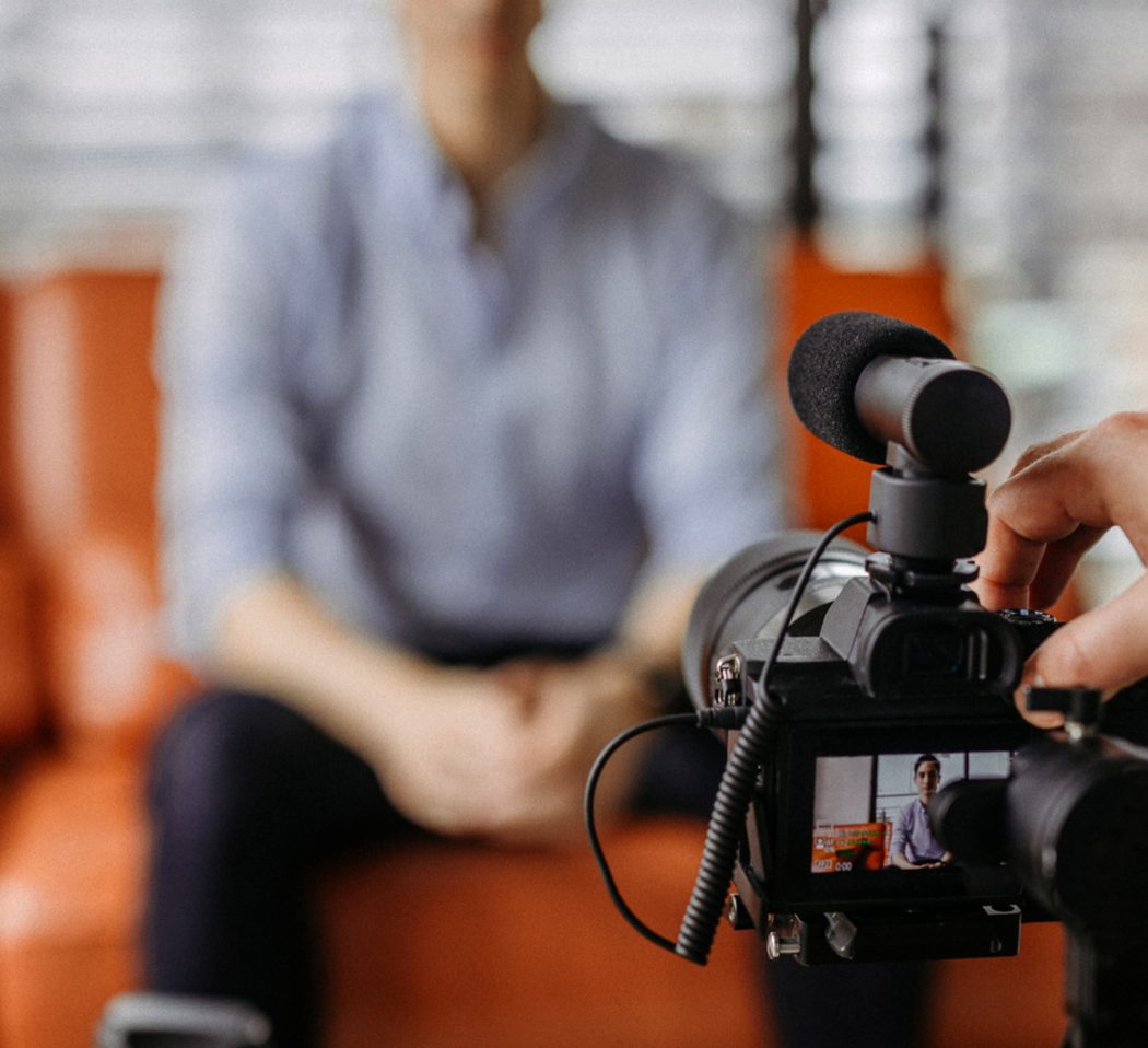 Camera operator setting up a shot for an interview